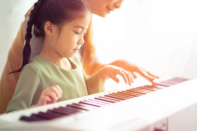 Girl playing with piano
