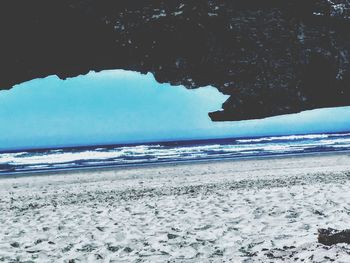 Scenic view of beach against blue sky