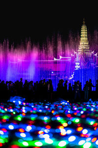 Group of people in illuminated building at night