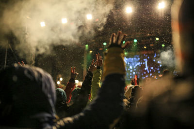 People enjoying music concert at night