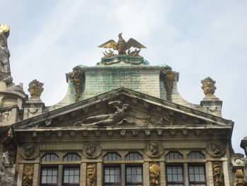 Low angle view of historical building against cloudy sky