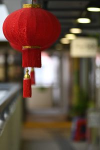 Close-up of red lantern hanging against building