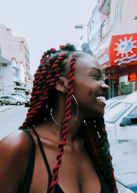 Portrait of smiling woman in city