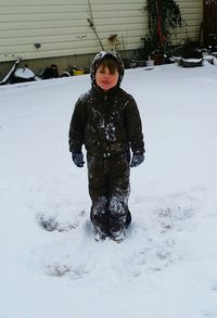 Girl playing on snow field during winter