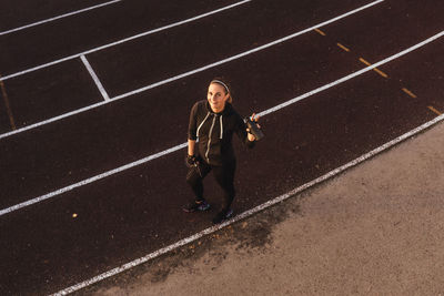 High angle view of man with umbrella on road in city