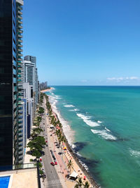 Panoramic view of sea and buildings against blue sky