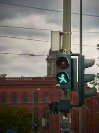 View of road sign against cloudy sky