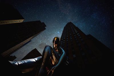 Low angle view of man against sky at night