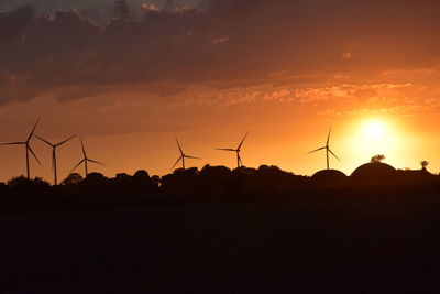 Scenic view of silhouette field against sky during sunset