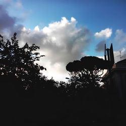 Low angle view of silhouette trees against sky