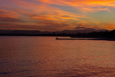 Scenic view of sea against orange sky