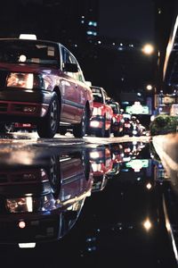 Close-up of cars on road at night