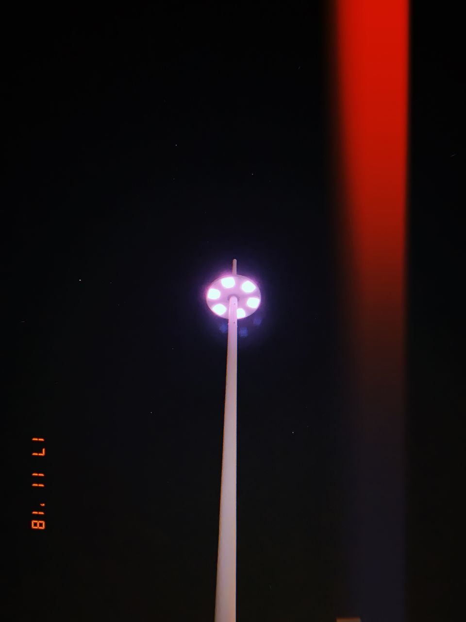 LOW ANGLE VIEW OF ILLUMINATED STREET LIGHTS AT NIGHT