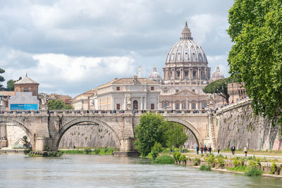 Arch bridge against cloudy sky