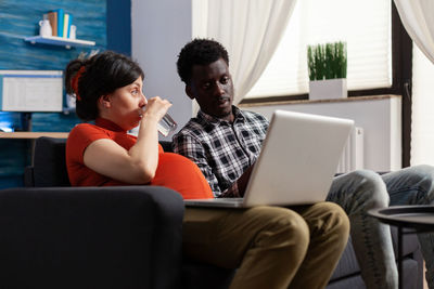 Young woman using laptop at home