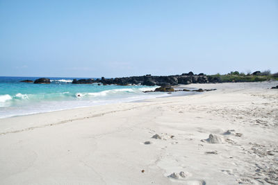 Scenic view of beach against clear sky