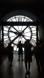 Silhouette people walking in subway station