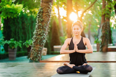 Woman exercising on mat at park