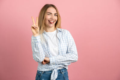 Portrait of a smiling young woman against red background