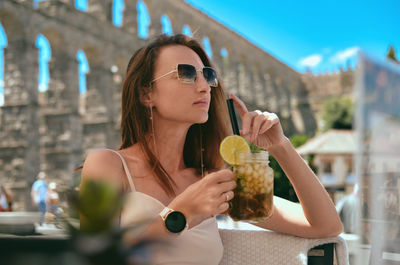 Young woman drinking glass of a restaurant