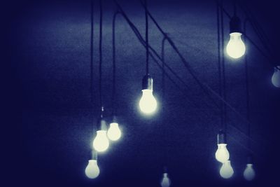 Low angle view of illuminated lamp post at night