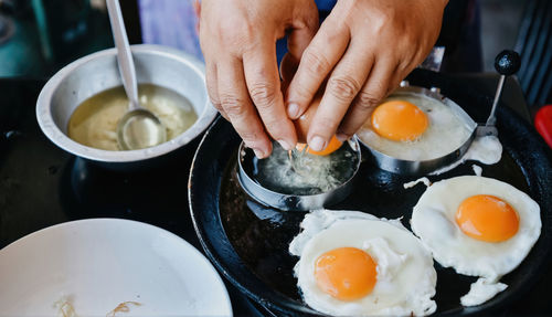 Cropped hand of person preparing food