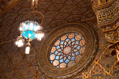 Low angle view of illuminated chandelier in building