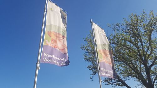 Low angle view of pole against blue sky