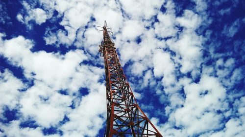 Low angle view of eiffel tower against cloudy sky