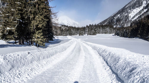 Snow covered field against sky