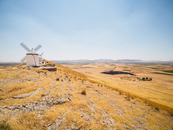 Traditional windmill on field against sky