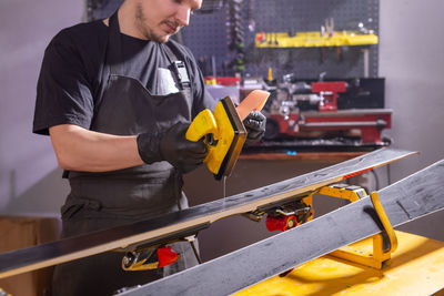 Midsection of worker working at factory