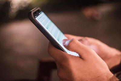 Midsection of woman using mobile phone