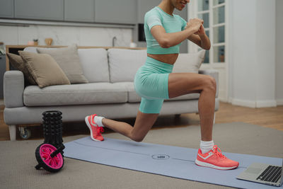 Full length of woman exercising in gym