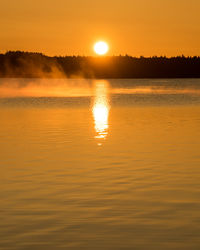 Scenic view of lake against romantic sky at sunset