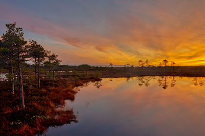 Scenic view of lake against orange sky
