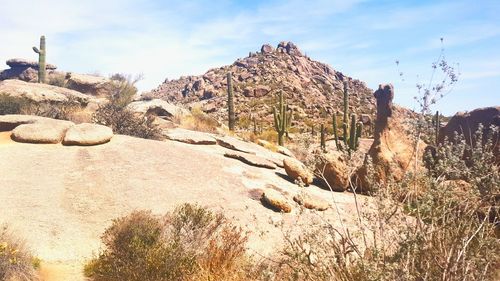 Rock formations on landscape against sky