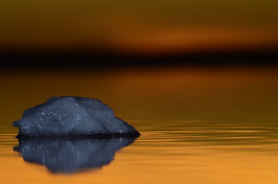 Close-up of sea against sky during sunset