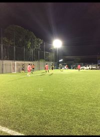 Group of people playing soccer on field