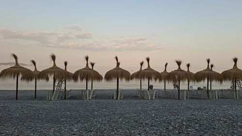 Scenic view of beach against sky during sunset