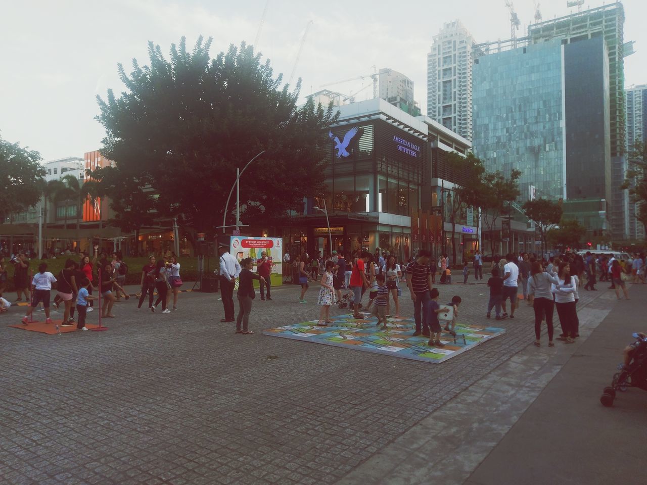 city, large group of people, building exterior, tree, architecture, city life, real people, sky, outdoors, women, built structure, men, day, people, adults only, adult