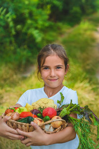 Portrait of smiling young woman holding food