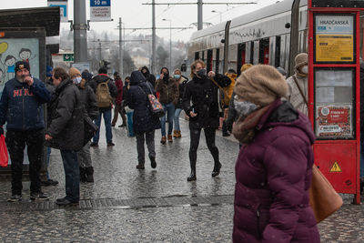 People walking on street in city during winter