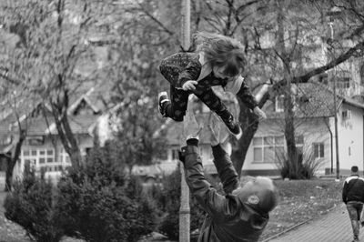 Man playing with daughter at park