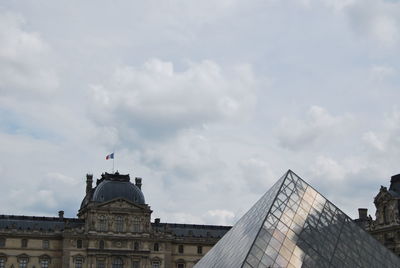Low angle view of building against cloudy sky