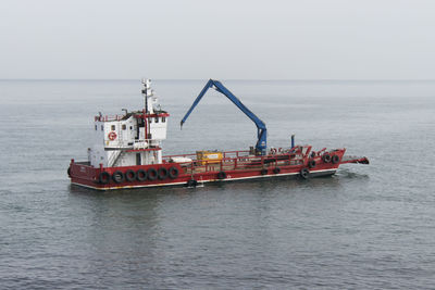 Ship in sea against clear sky