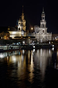 Reflection of illuminated buildings in city at night