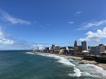 Sea and buildings against sky