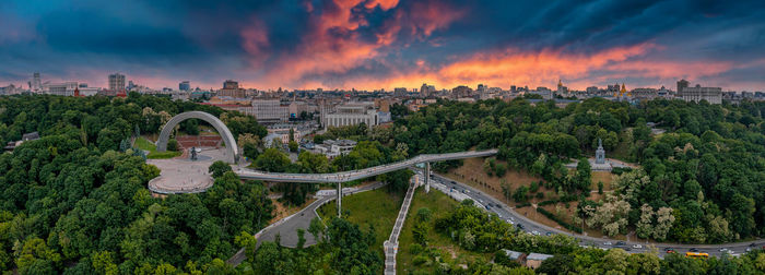 Sunset over summer kiev with arch of friendship of peoples.