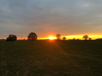 Scenic view of field against sky during sunset